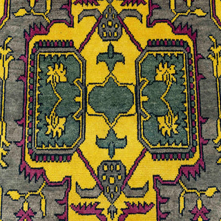 Hand-knotted wool rug featuring geometric medallion and floral motifs in yellow, green, gray, 8x10.