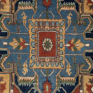 Hand-knotted wool rug featuring geometric medallion pattern in blue, rust, gold, 9x12 feet.