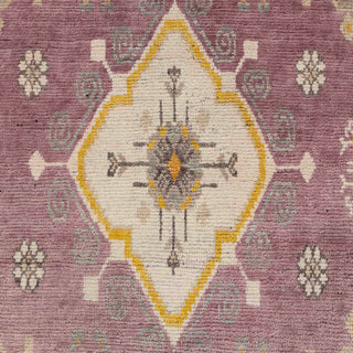Hand-knotted wool rug featuring geometric medallions and floral motifs in plum, mustard, ivory, 8x10