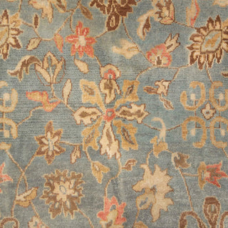 Hand-knotted wool rug featuring intricate Persian floral vines in blue, ivory, tan tones, 8x11 size.