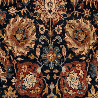 Hand-knotted wool rug featuring intricate floral pattern on deep navy field with warm beige and rust accents, 6x9 ft