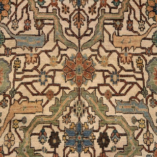 Hand-knotted wool rug featuring ivory field, rust border and teal geometric pattern