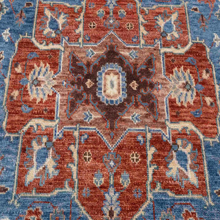 Hand-knotted wool rug featuring large Heriz-style medallion, blue field, rust border, ivory accents, 8x10.