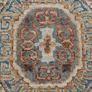 Hand-knotted wool rug featuring layered geometric medallion and tribal motifs in beige, rust, teal, blue, 9x12 size