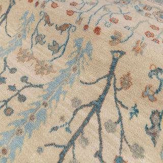 Hand-knotted wool rug featuring mirrored trees, vines and blossoms in ivory, light blue and rust, 9x12 ft.