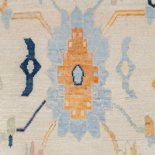 Hand-knotted wool rug featuring modern Oushak pattern in ivory, navy, peach, blush, sky blue, 9x12 size