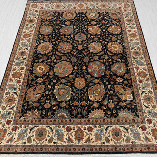 Hand-knotted wool rug featuring navy field, ivory floral border, Persian allover pattern, 8x10