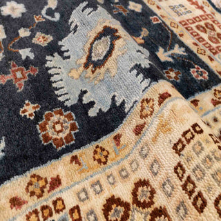 Hand-knotted wool rug featuring navy field with scattered floral motifs and cream geometric border, 8x10 size