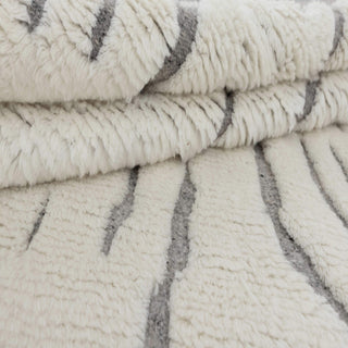 Hand-knotted wool rug featuring organic vertical grey lines on ivory ground with tassels, 8x10.