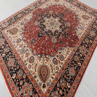 Hand-knotted wool rug featuring ornate floral medallion and ivory corners in red, navy, and blue-grey tones, 8x10 ft