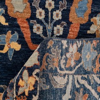 Hand-knotted wool rug featuring oversized Ikat floral pattern in navy, rust, teal, beige, approx. 8x10 ft.