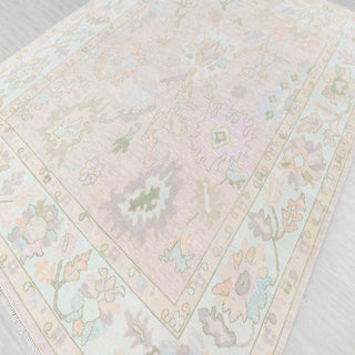 Hand-knotted wool rug featuring oversized Oushak florals in blush, aqua, lavender, sage, 9x12 size
