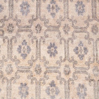 Hand-knotted wool rug featuring small floral lattice pattern in cream, taupe, blue-grey, 6x9 size.