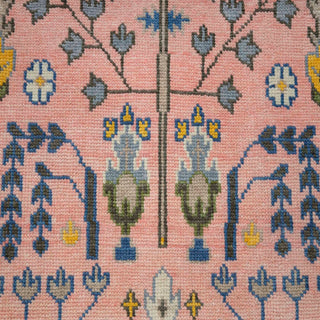 Hand-knotted wool rug featuring stylized botanical stripe pattern in pink, ivory, blue, yellow, 9x12