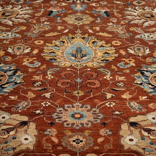 Hand-knotted wool rug featuring traditional botanical pattern in rust, blue, ivory, 10x14 size