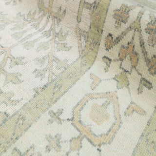 Hand-knotted wool rug featuring tree-of-life and botanical pattern in ivory, moss green, wheat, 9x12 size