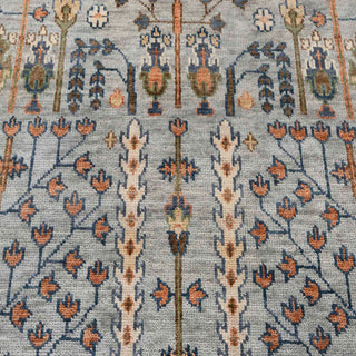 Hand-knotted wool rug featuring tree-of-life floral rows on blue field with rust border, 8x10 ft