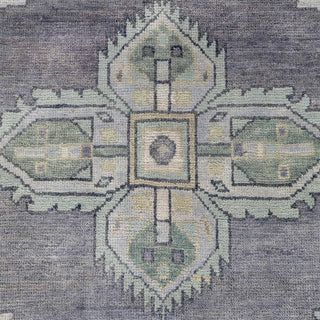 Hand-knotted wool rug featuring tribal cross medallions in charcoal gray, mint, cream, 8x10.

