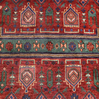 Hand-knotted wool rug featuring tribal prayer pattern in rust, blue, green, cream, 8x10 area rug.