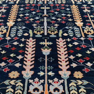 Hand-knotted wool rug featuring vertical tree-of-life and floral motifs in navy, cream, pastel tones, 8x10 ft.