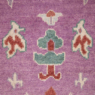 Hand-knotted wool rug featuring whimsical Oushak motifs in lilac, green, terracotta, 8x10 size.