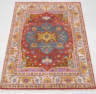 Hand-knotted wool rug in rust, teal, gold with geometric medallion and floral design, 8x10.