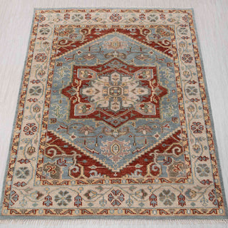 Hand-knotted wool rug in sky blue, ivory, rust with large geometric medallion design, 8x10.