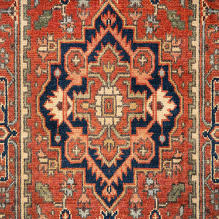 Hand-knotted wool runner rug featuring bold Heriz medallion pattern in rust, navy, cream, 2.6x10