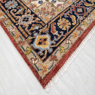 Handmade wool area rug 8x10 with rust field, navy border, blue accents and medallion design.