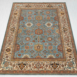 Heriz-style hand-knotted rug in blue, rust, and ivory with dense floral medallion design, 8x10.