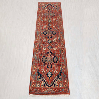 Heriz-style hand-knotted runner in rust red, navy, teal with geometric medallion design, 2.6x10