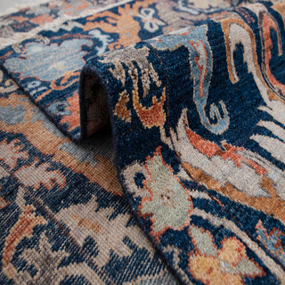 Indo-Persian hand-knotted rug with symmetrical palmette motif in navy orange rust.