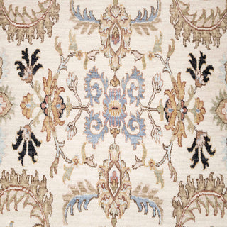 Kashan-style hand-knotted rug with allover floral motif in ivory, light blue, camel tones.