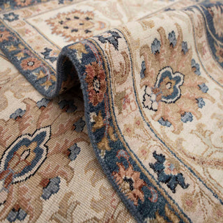 Kashan-style hand-knotted rug with allover floral motif in navy blue, ivory, camel tones.