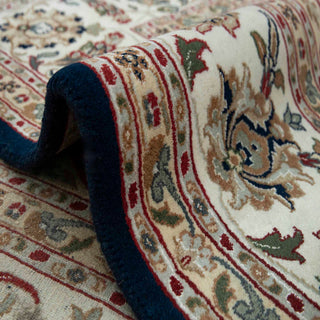 Kashan style hand-knotted rug with central medallion motif in navy, ivory, beige and red