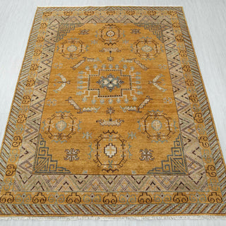 Kazak-style hand-knotted rug in golden ochre, beige, blue with geometric medallion design, 8x10.