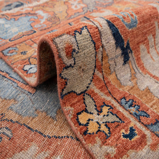 Kazak-style hand-knotted rug with tree palmette motif in terracotta teal ivory, 6x9 area.