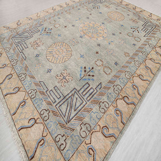 Khotan-style hand-knotted rug with round medallion and border motif in celadon, sand, and sky blue.