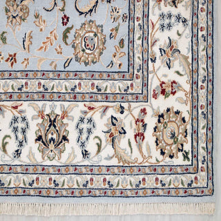Luxury Persian-style 8x10 living room rug, pale blue field, ivory border, detailed floral decoration.