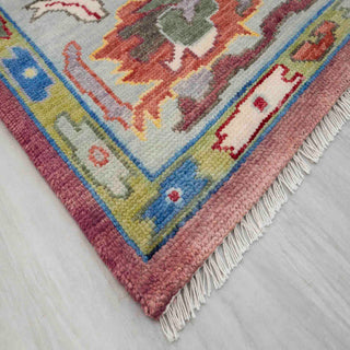 Modern Oushak hand-knotted rug with abstract floral pattern in muted red, blue, yellow, perfect living room