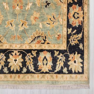 Modern classic hand-knotted rug with ornate floral pattern on green field, navy border, 5x8

