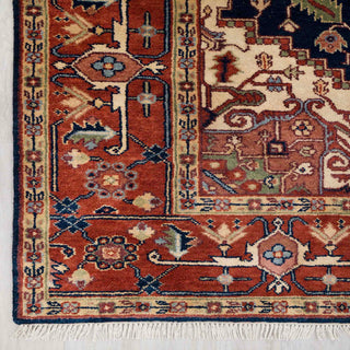 Modern classic hand-knotted rug with strong geometric medallion and border in navy, rust, beige.