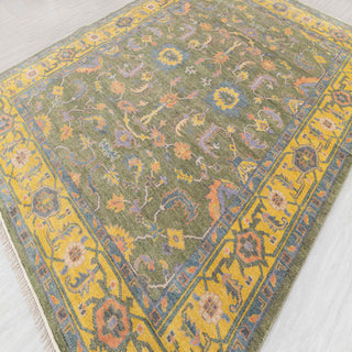 Modern classic hand-knotted rug with stylized allover floral design in olive, sunflower yellow, and blue.