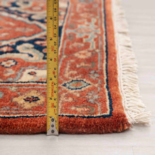 Modern classic hand-knotted runner with bold medallion pattern on rust field, navy border, 2.6x10