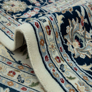 Modern classic hand-knotted wool rug with ornate medallion pattern in ivory and navy tones