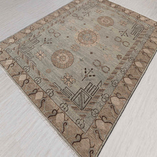 Modern hand-knotted rug with abstract Khotan-inspired geometric pattern in muted green and camel