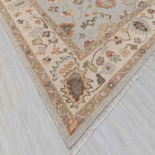 Modern hand-knotted rug with abstract Oushak-inspired floral pattern in blue, ivory, taupe.