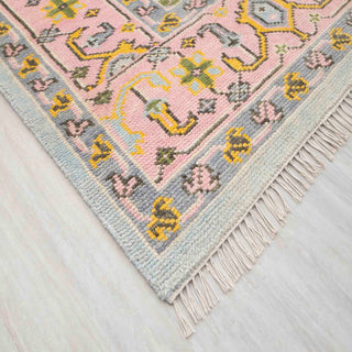 Modern hand-knotted rug with abstract Oushak-inspired pattern in pastel mint, pink, mustard, and olive.