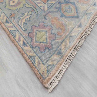 Modern hand-knotted rug with abstract Oushak-inspired pattern in peach, sky blue, soft pastels