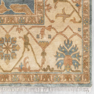 Modern hand-knotted rug with abstract floral pattern in blue, camel, cream, soft low pile.

